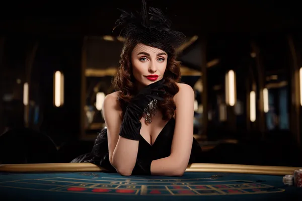 A glamorous woman holding casino chips in a neon-lit environment, representing the premium online casino atmosphere of JL29.