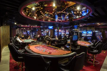 A close-up shot of golden coins falling around a spinning roulette wheel, representing immersive casino action at JL29.